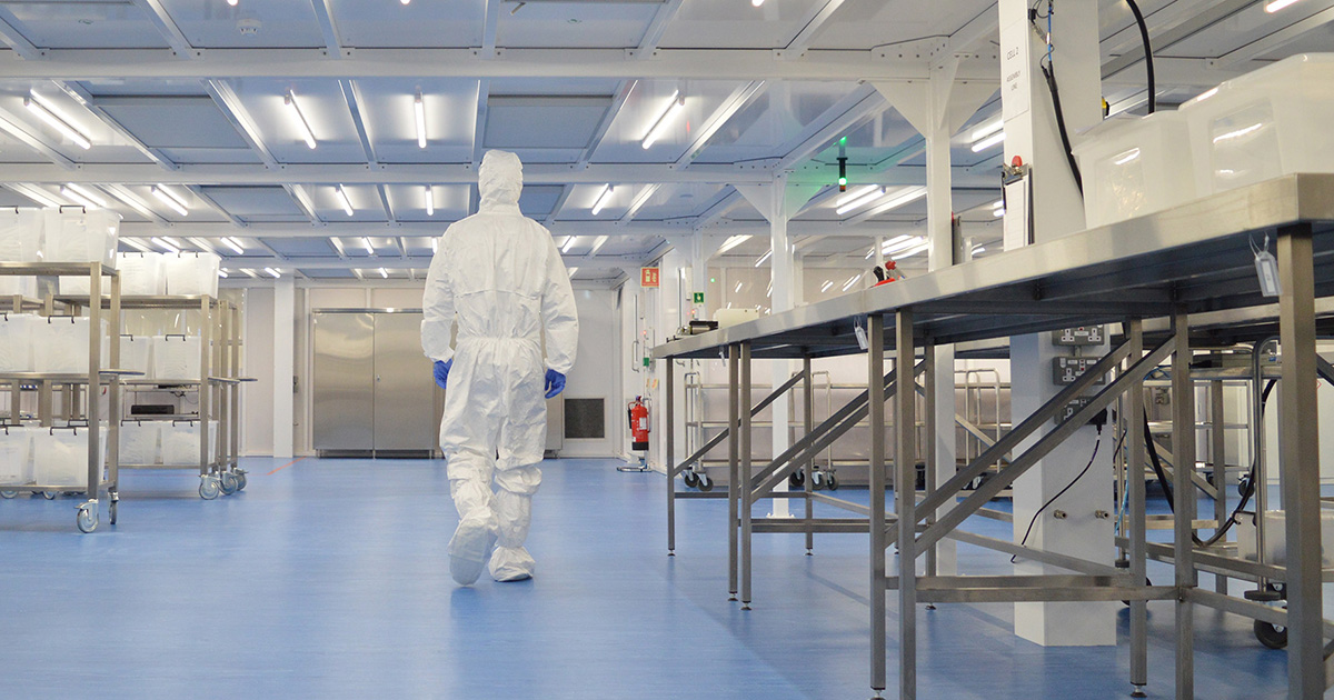 Operative walking through a cleanroom with stainless steel furniture
