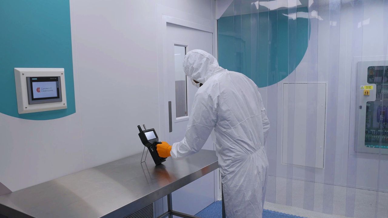 A cleanroom operator using a particle counter