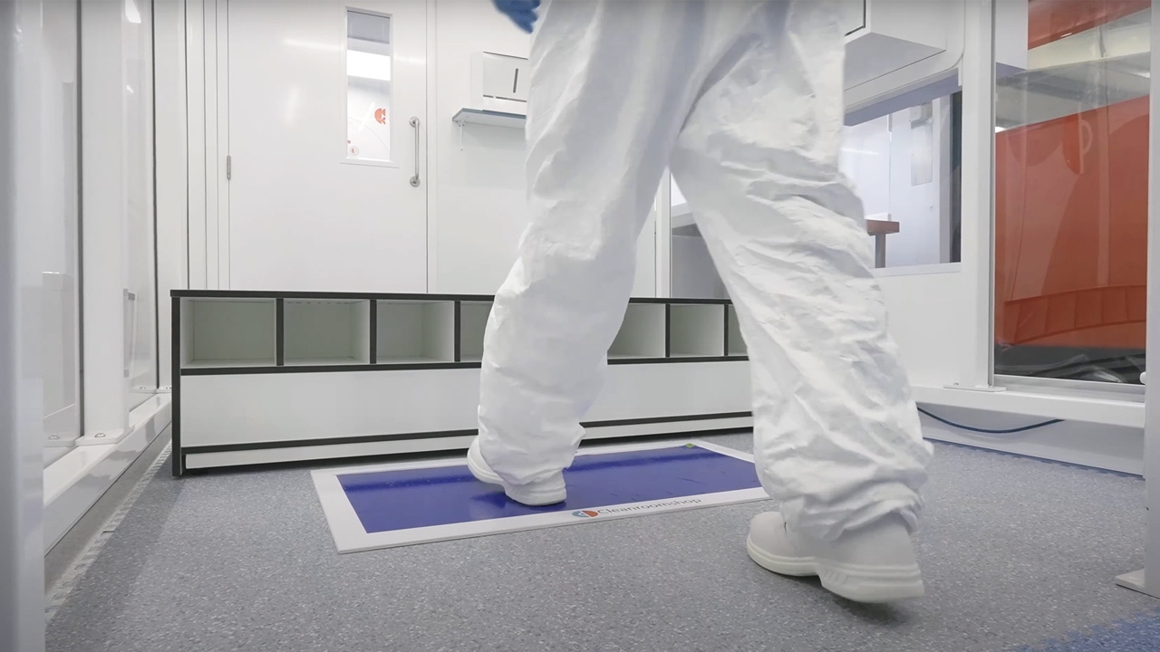Cleanroom operator walking over a tacky mat